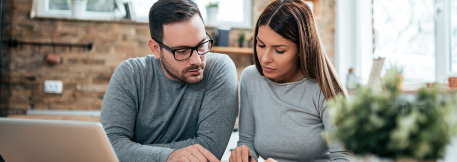a couple reviews their personal finances to determine if consolidating debt is a good idea for them