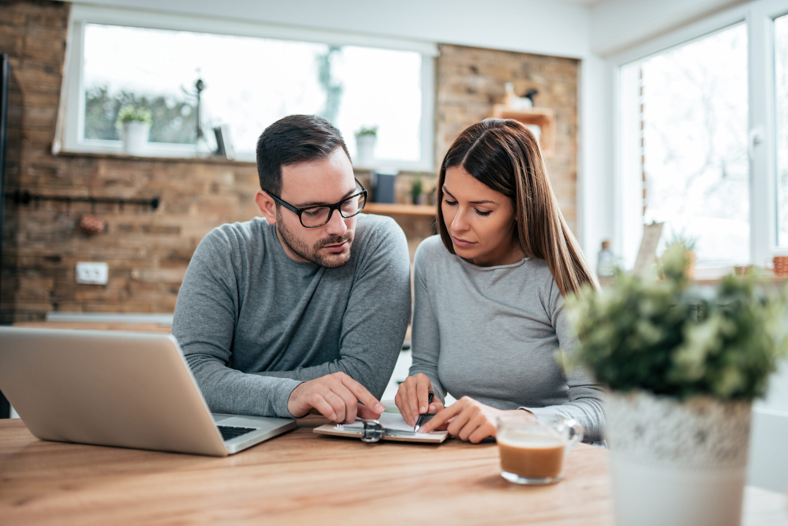 a couple reviews their personal finances to determine if consolidating debt is a good idea for them