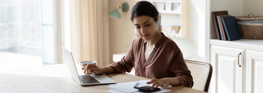 a woman calculates her debt to decide what type of personal loan is best for her
