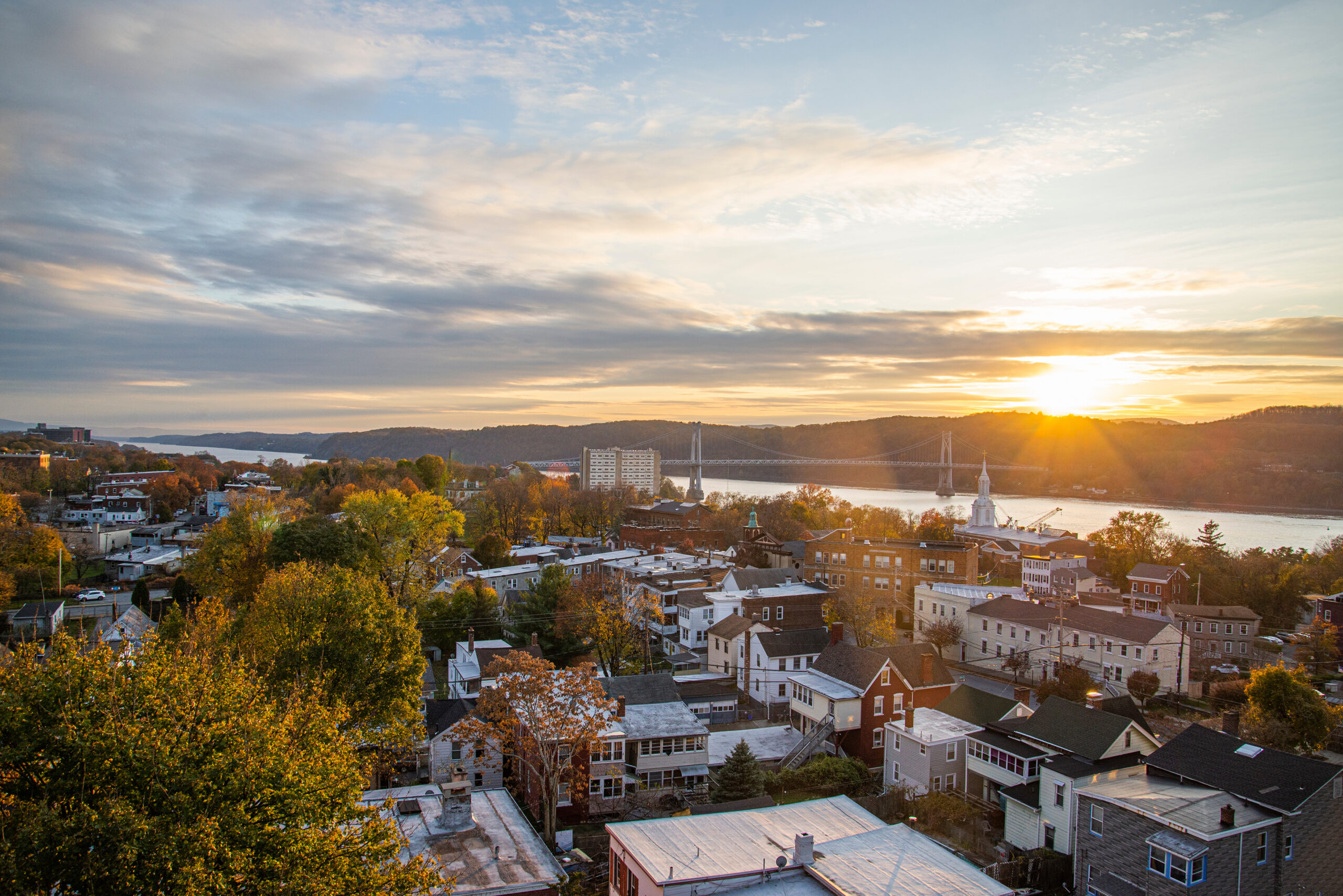 the sun setting over a residential area of homes in Hudson Valley, NY