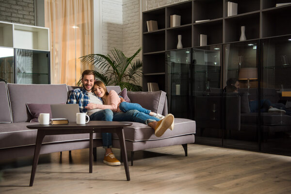 a couple relaxes on their couch after choosing a HELOC vs. home equity loan to buy new furniture for their home
