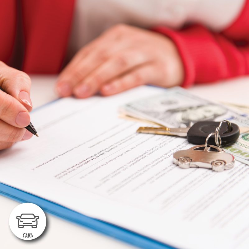 An individual signing an auto loan application.