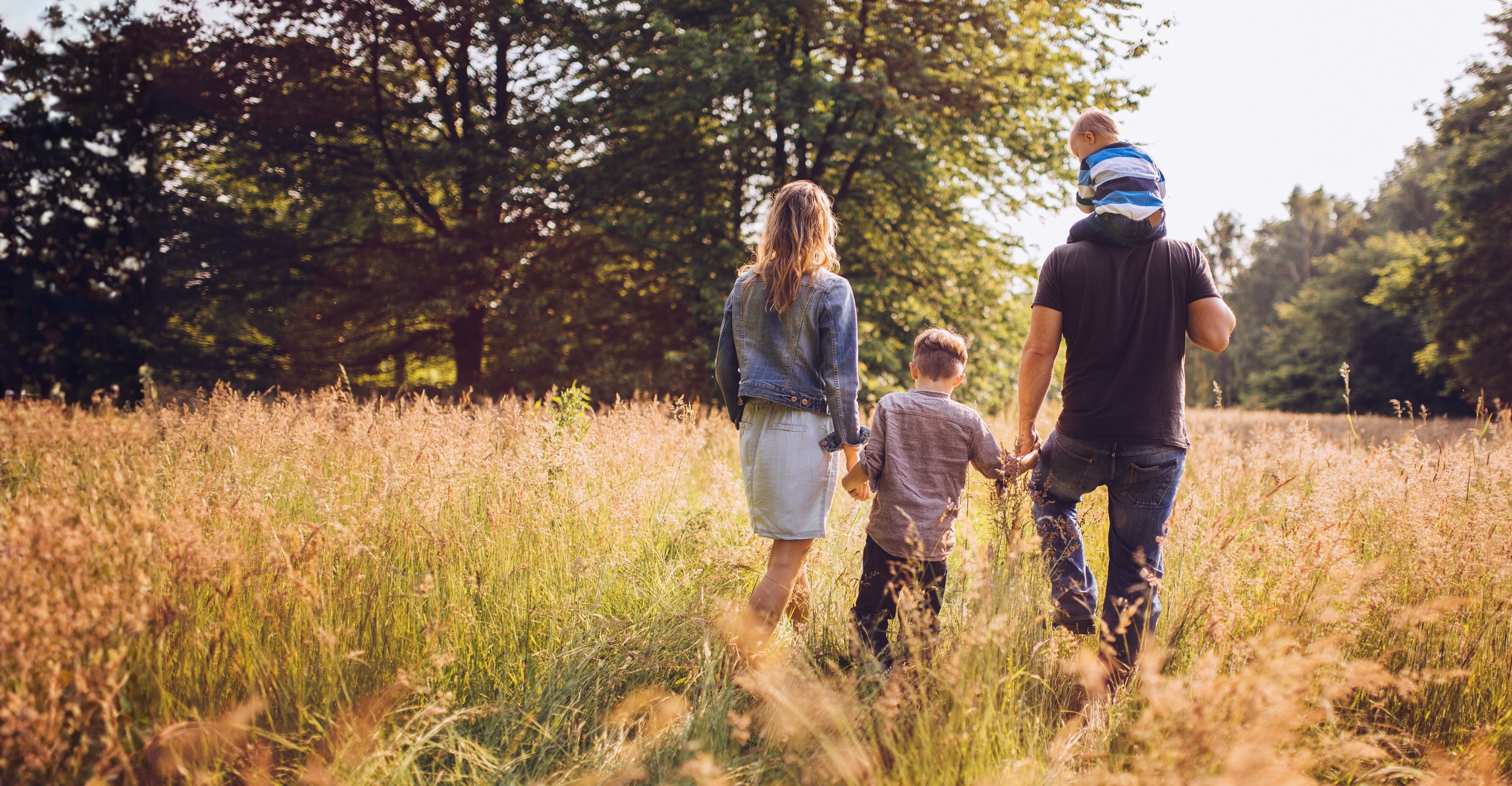 Family walking through a field