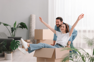 Couple celebrating their down payment on a Hudson Valley home purchase with moving boxes