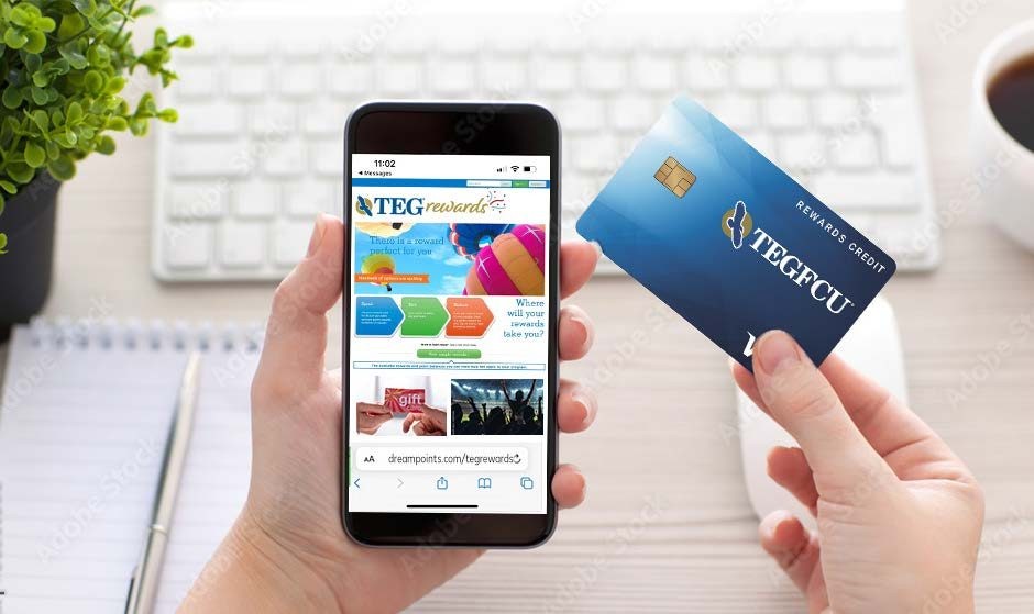 A hand holding a TEGFCU Rewards credit card next to a phone showing the TEG Rewards site