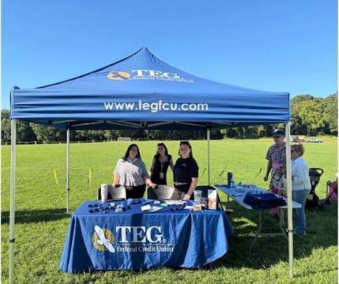 TEG team members at a community event tent
